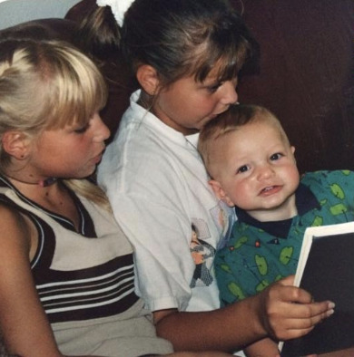 Jennifer reading with her siblings