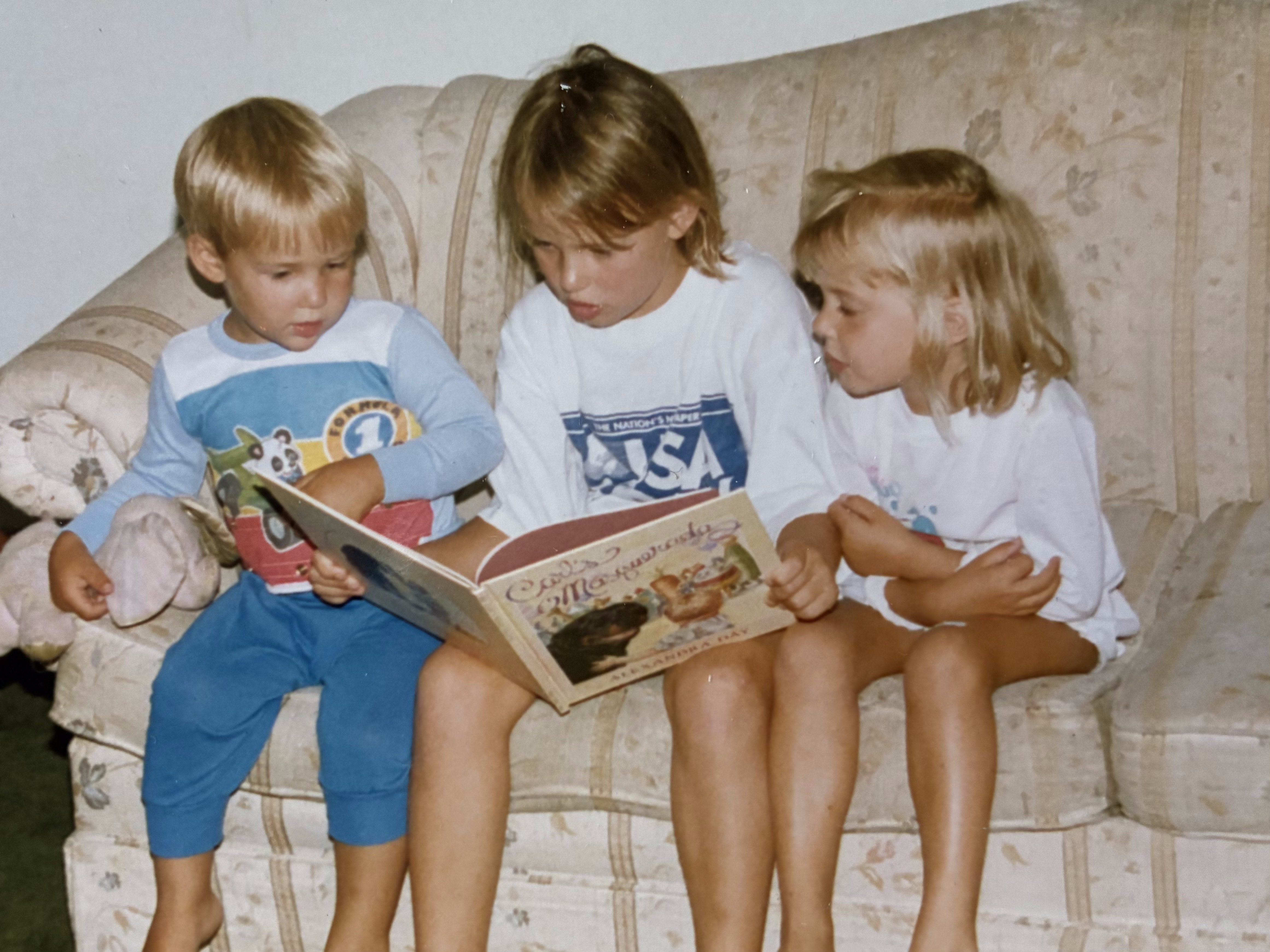 Kaitlyn reading with her siblings
